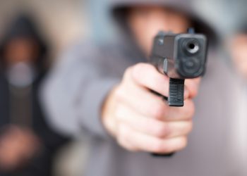 Un ragazzo impugna una pistola (immagine huffpost.com)